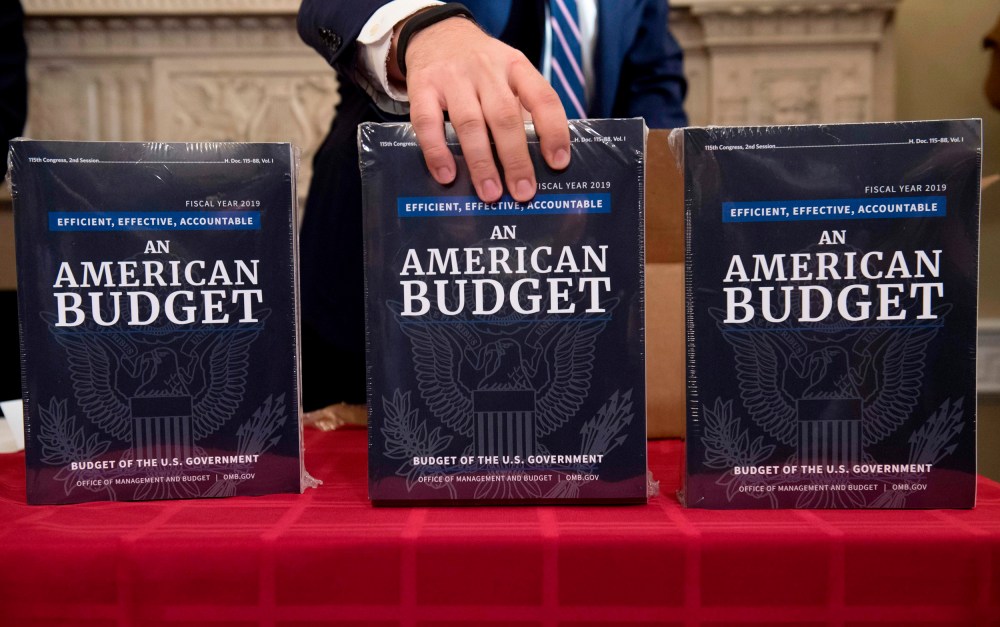 Image: A Congressional staff member delivers copies of the government budger