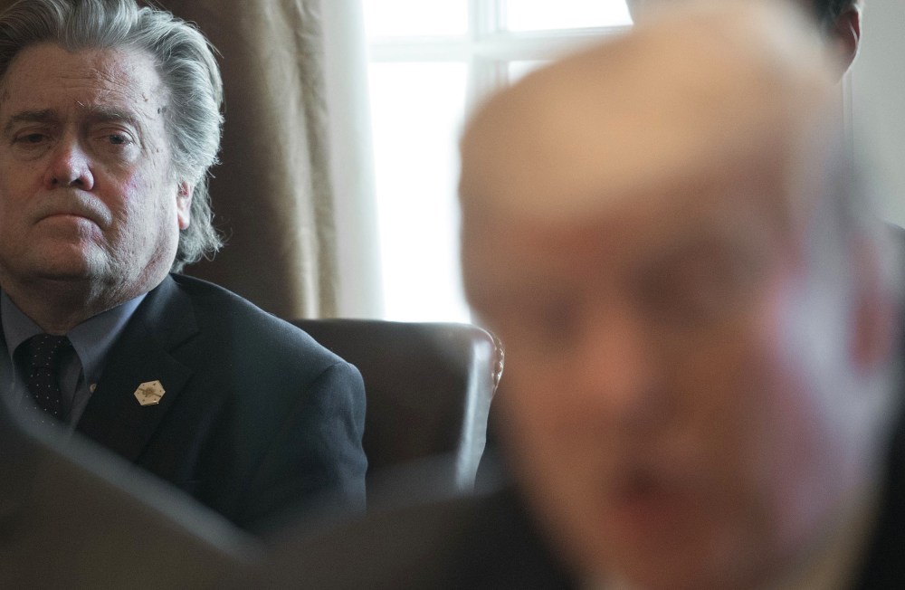 Image: Steve Bannon listens as President Donald Trump speaks to the media