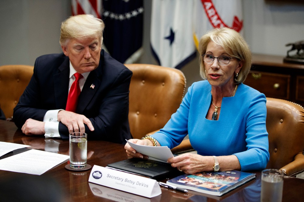 President Donald Trump listens as Secretary of Education Betsy DeVos speaks discusses the Federal Commission on School Safety report