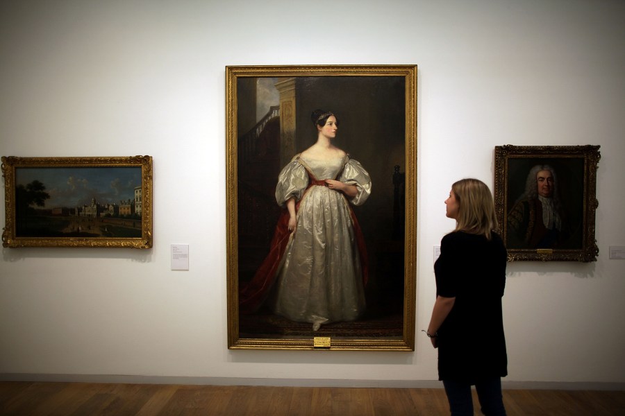Image: A gallery employee looks at Margaret Carpenter's painting 