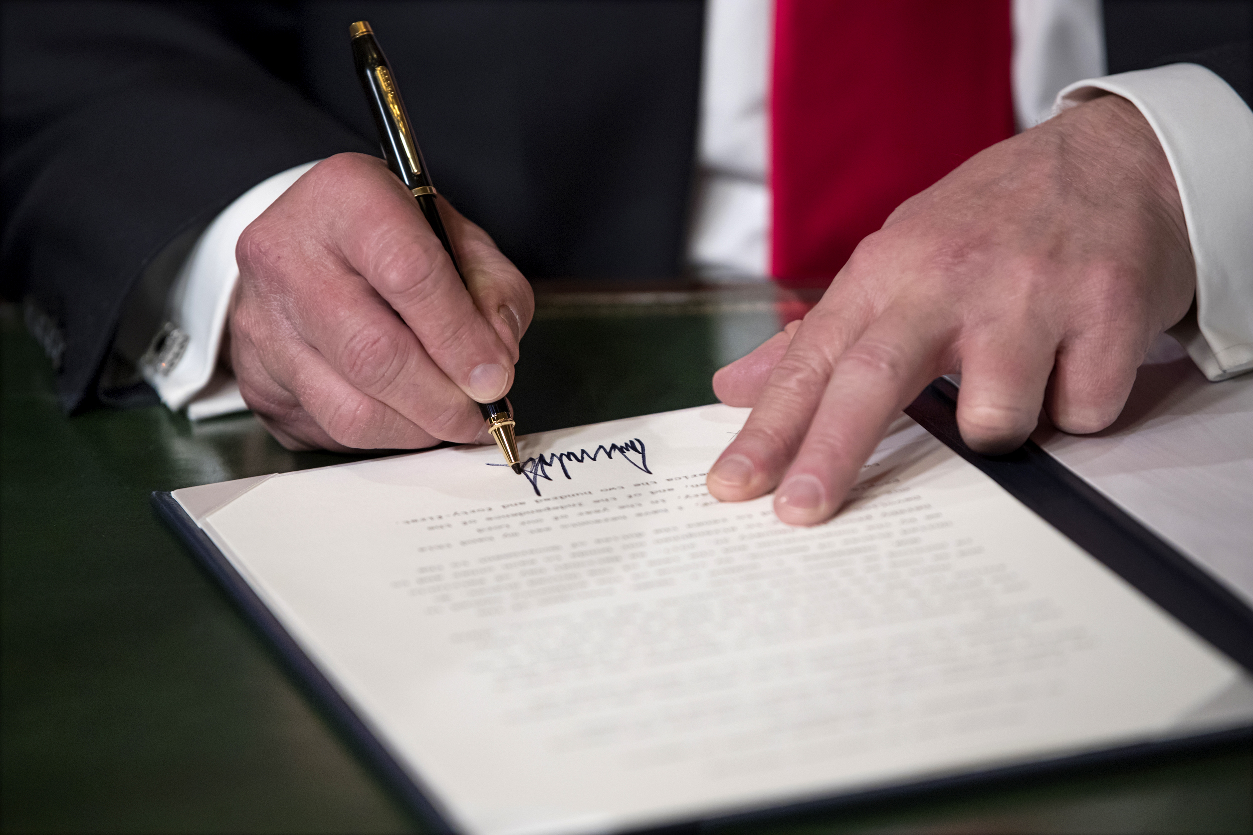Image: President Donald Trump signs his cabinet nominations into law on Jan. 20, 2017.
