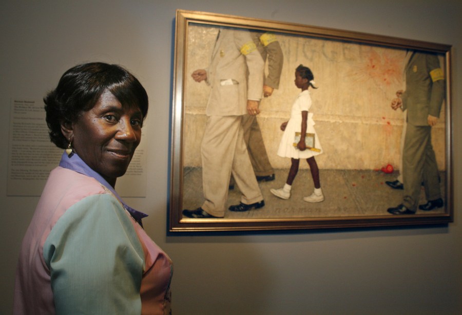 Image: Lucille Bridges looking at the original 1964 Norman Rockwell painting showing her daughter Ruby, 