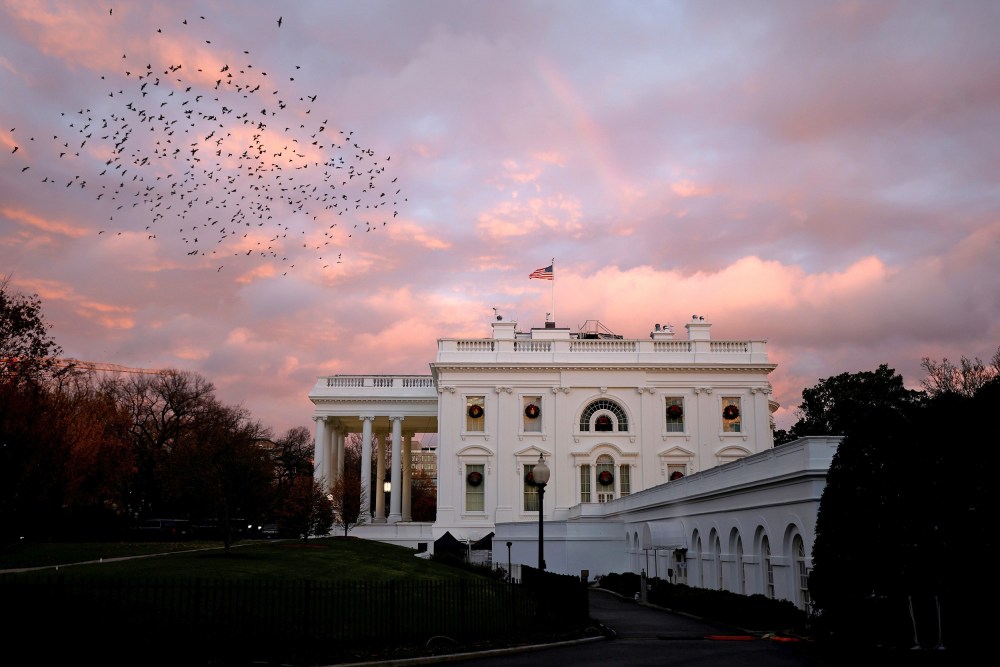 Image: A rainbow appears over the White House as birds fly nearby following a storm in Washington