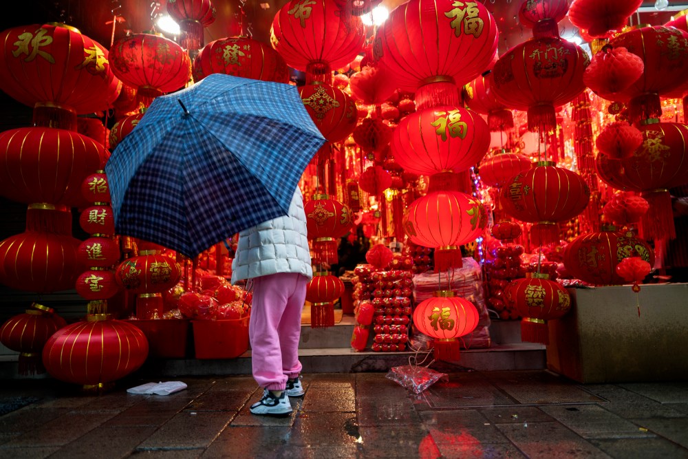 Image; A woman shops for lanterns ahead of Chinese New Year in Shaoxing, China, on Feb. 11, 2021.