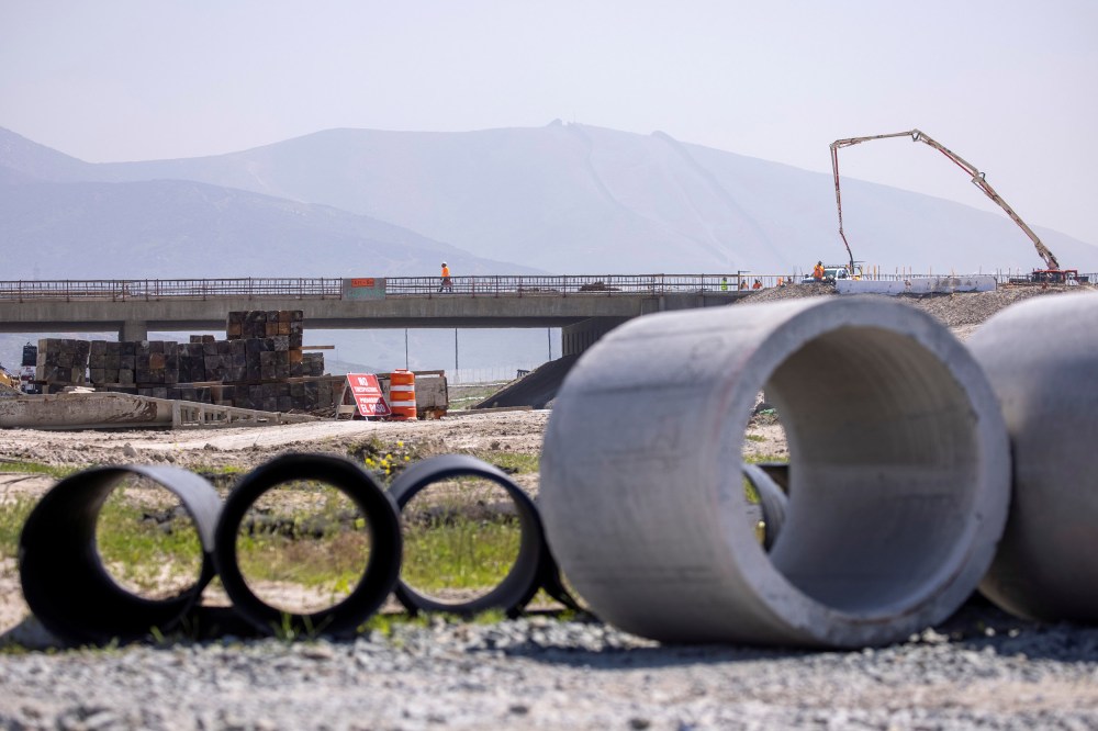 Image: Work crews continue to work on the construction of a freeway overpass in San Diego