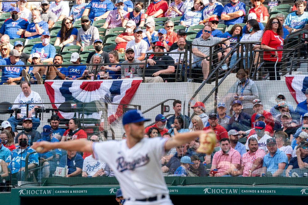 Image: Texas Rangers fans watch relief pitcher Kyle Cody work against the Toronto Blue Jays during the seventh inning of a game April 5, 2021, in Arlington, Texas.