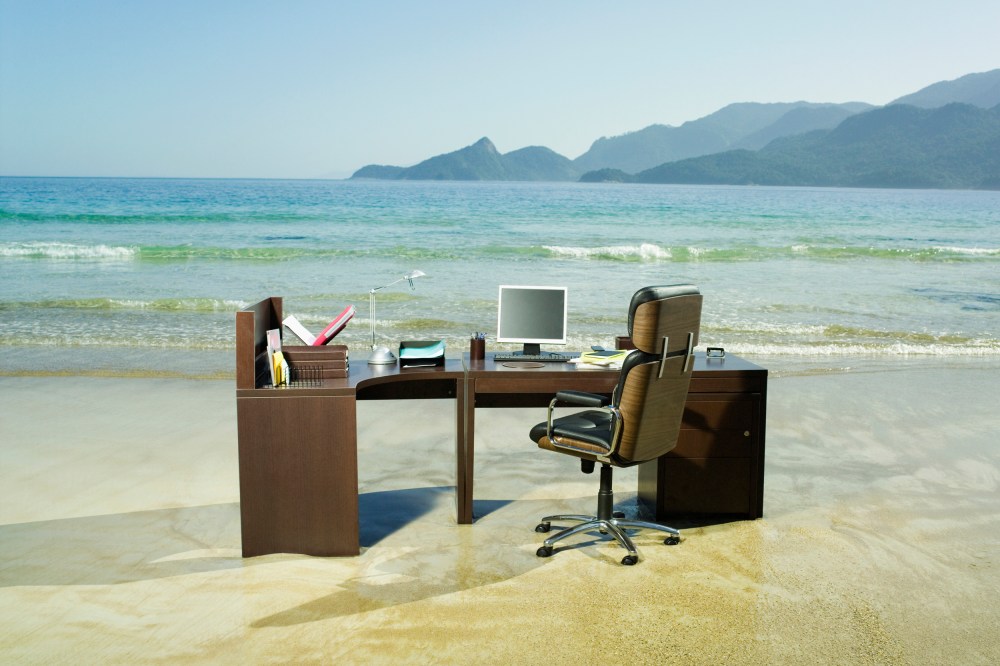 Office desk on beach.