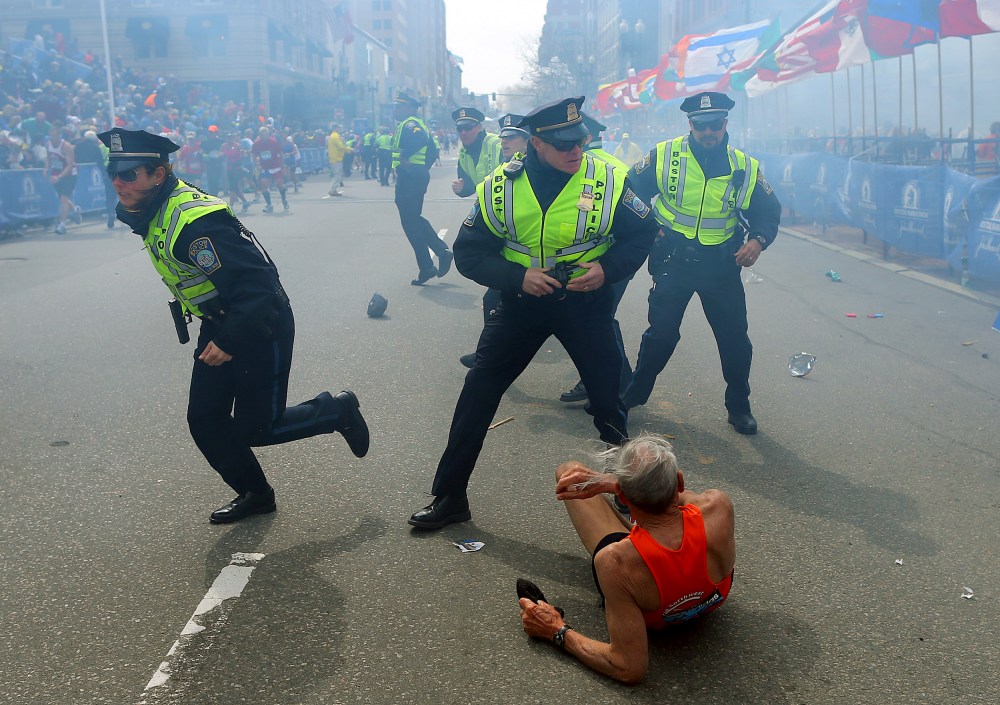 Image: Police officers draw their guns as a second explosion occurs during the Boston Marathon on April 15, 2013.