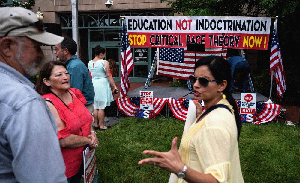 Image: People talk before a rally against critical race theory at the Loudoun County Government Center in Leesburg, Va., on June 12, 2021.