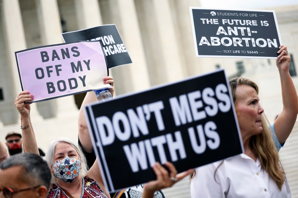 Abortion rights and anti-abortion activists protest alongside each other outside of the Supreme Court on Oct. 4, 2021, in Washington.