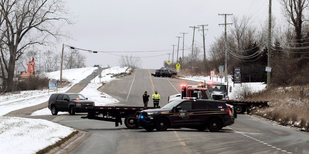 Image: Police cars blocking a road.