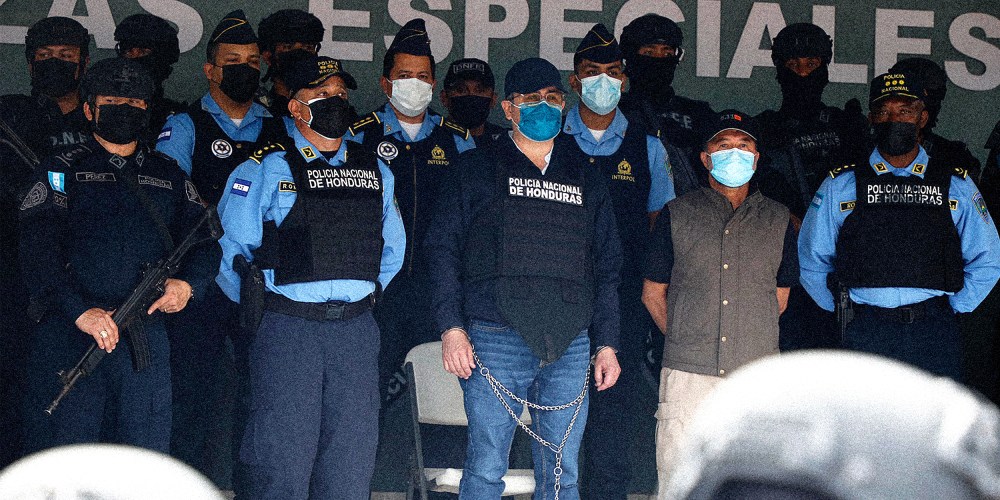Image: Former Honduran President Juan Orlando Hernandez, center in chains, at the Police Headquarters in Tegucigalpa, Honduras.