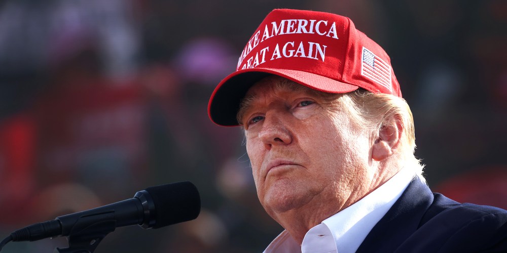 Image: Donald Trump wearing a red hat that reads, "Make America Great Again".