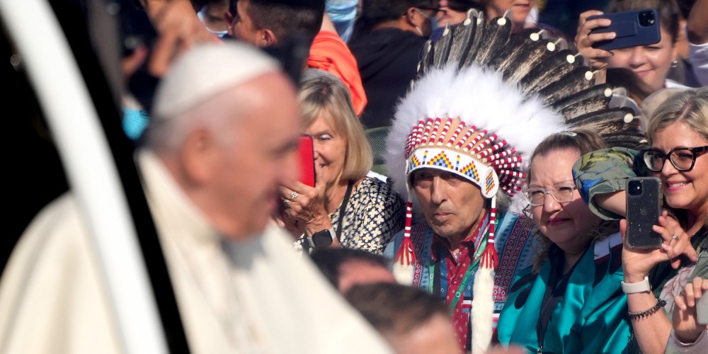 Image: Pope Francis arrives at the Commonwealth Stadium to celebrate mass as Phil Fontaine stands in the audience watching him.