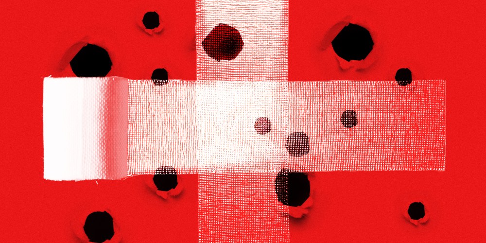 Photo illustration of two bandages crossing each other at the centre, covering a red surface with holes.