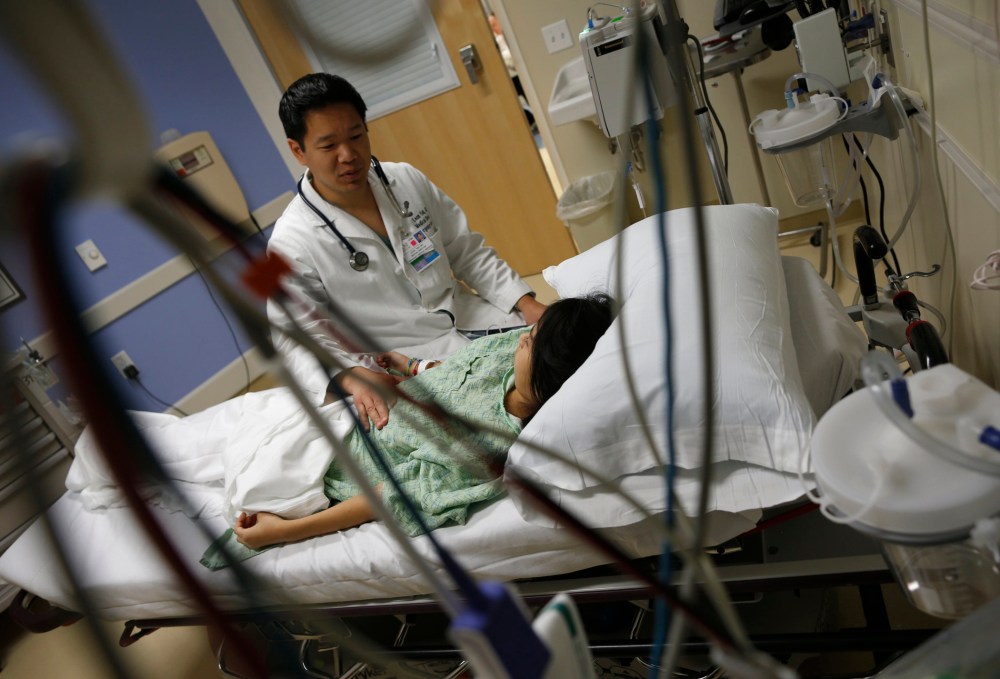 Patient Analy Navarro speaks with Doctor Leon Yeh in the Emergency Room at OSF Saint Francis Medical Center in Peoria, Illinois, November 26, 2013.