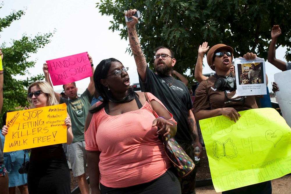 Image: Protestors continued "no justice, no peace" chants at the St. Louis County Justice Center in Clayton