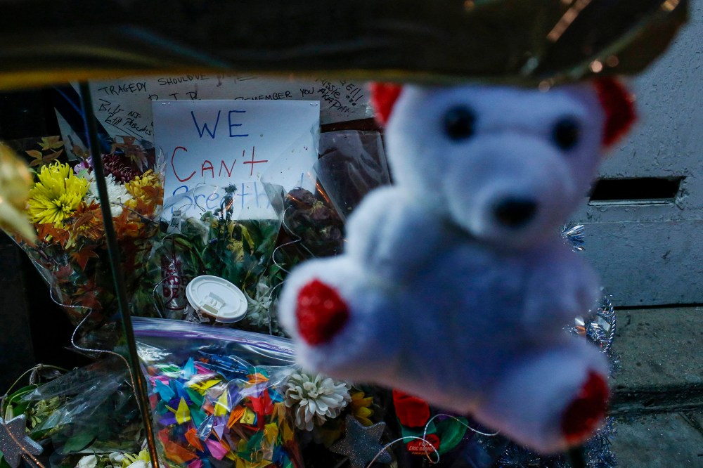 Image: A sign is seen at a makeshift memorial where Garner died during an arrest in July in the Staten Island borough of New York