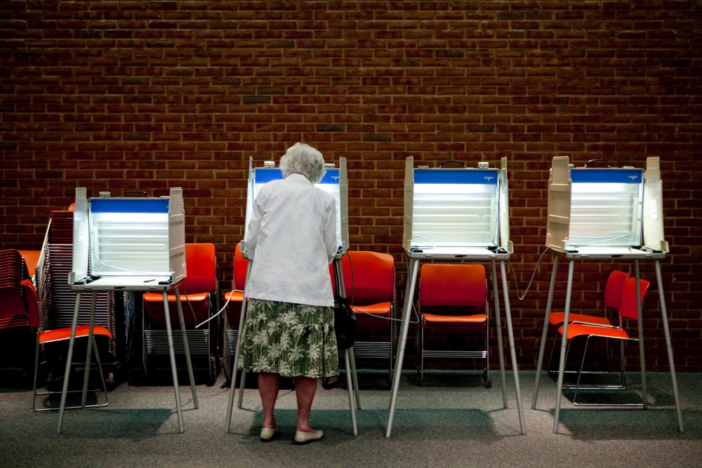 A voter casts her ballot in the primary election in Maryland Heights, Missouri, August 3, 2010.