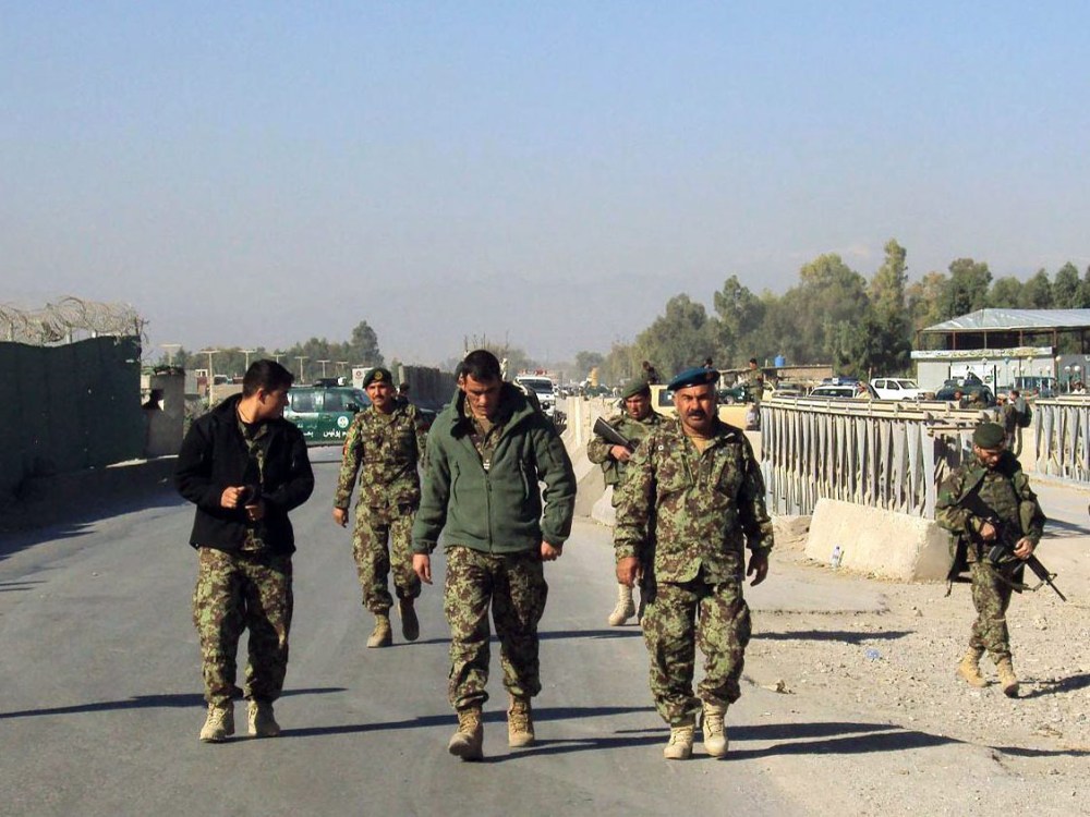 Afghan National Army soldiers stand guard outside the US military base after a fierce gun battle between Taliban militants and Afghan security forces, in Jalalabad, Afghanistan, 02 December 2012. (Photo by Abdul Mieed/EPA)