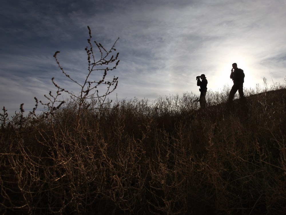 File Photo: U.S. Border Patrol agents Richard Funke and Colleen Agle look for illegal immigrants crossing the U.S.- Mexico border on December 7, 2010 near Nogales, Arizona. Although a new fence has been built along the majority of Arizona's border with...