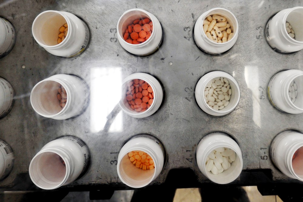 Bottles of prescription pills go through an automated packaging machine in the Medco pharmacy plant in Willingboro, New Jersey.