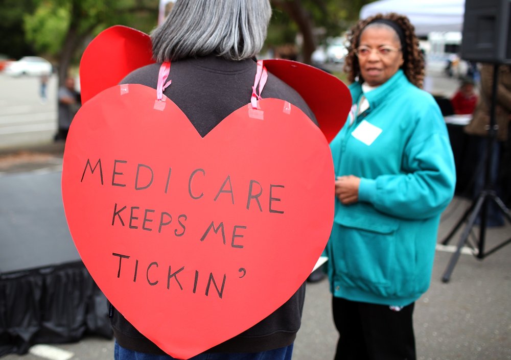 A senior citizen holds a sign during a rally to protect federal health programs at the 8th Annual Healthy Living Festival on July 15, 2011 in Oakland, California.
