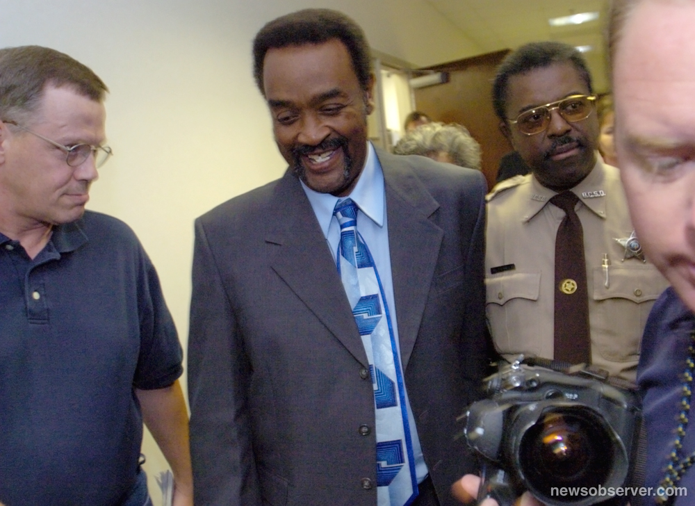 Sylvester Smith, center, smiles after he was granted a new trial after two witnesses recanted their testimony in a Brunswick County courtroom in Bolivia, N.C., Nov. 5, 2004. He had wrongfully served 20 years on a sexual assault charge.