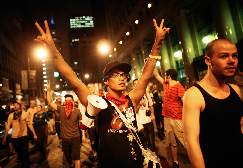Demonstrators flash the peace sign during an anti-NATO protest march in Chicago May 20, 2012. Four police officers were injured and 45 demonstrators arrested after baton-wielding police clashed with anti-war protesters marching on the NATO summit in...