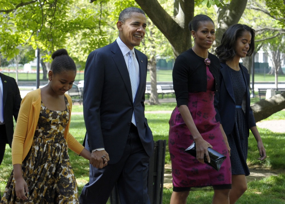 President Barack Obama, first lady Michelle Obama, daughters Malia, right, and Sasha walk across the square from the White House to St. John's Episcopal Church for Easter service in Washington Sunday, April 8, 2012.