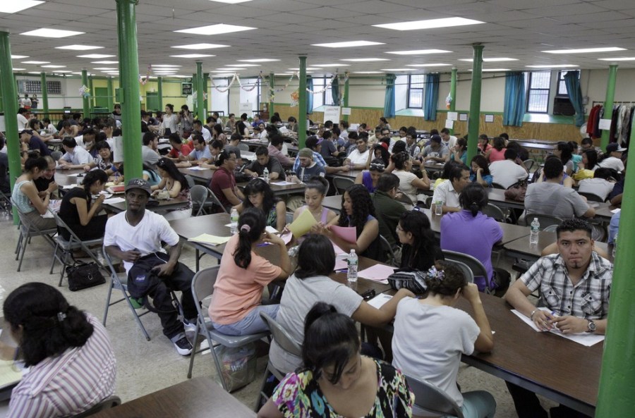 People fill the hall of  St. Mary's Church attending an orientation workshop and legal clinic for potential deferred action applicants, on New York's Lower East Side, Wednesday, Aug. 15, 2012. Hundreds of thousands of young undocumented immigrants...