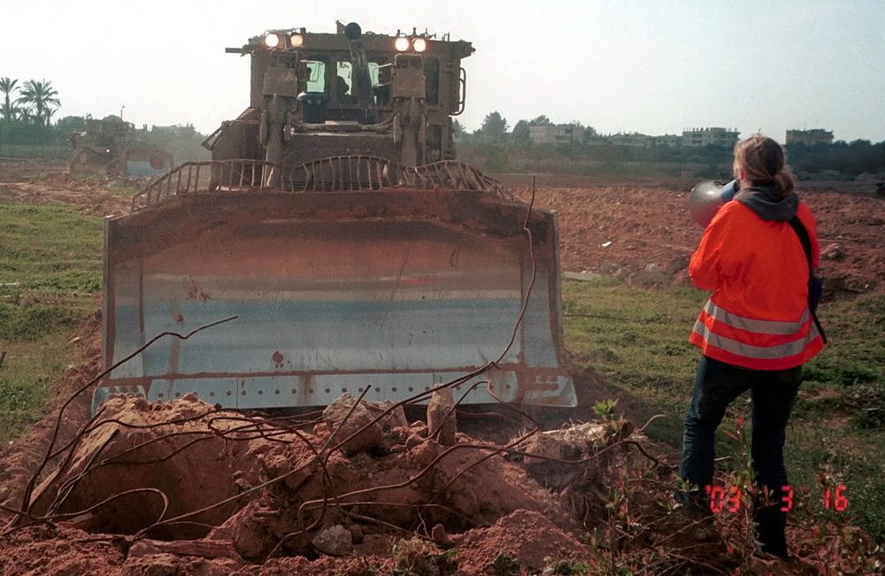U.S. citizen Rachel Corrie, 23, speaks through a megaphone to an Israeli army bulldozer on the day she was killed in Rafah, in the southern Gaza Strip on March 16, 2003.