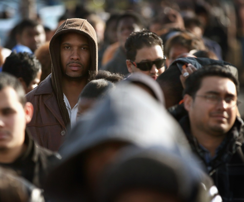 Job seekers wait in line at Kennedy-King College to attend a job fair hosted by the city of Chicago on November 9, 2012 in Chicago, Illinois. (Photo by Scott Olson/Getty Images)