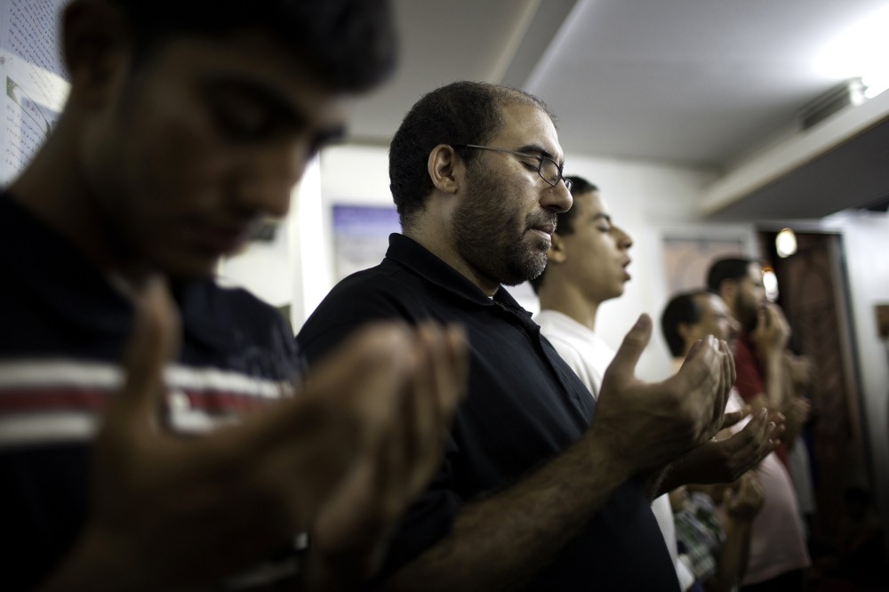 Muslim-American men offer evening prayers after breaking their day-long Ramadan fast on Aug. 24, 2011 at Islamic Center of Bay Ridge in the Brooklyn borough of New York.