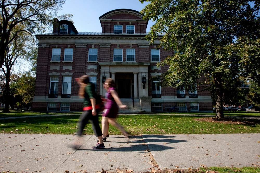 Students walk past an administration building on the Dartmouth College campus.