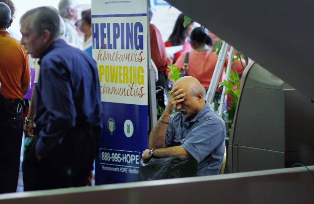 A man sits during a Help for Homeowners Community Event at the James L. Knight Center on February 22, 2012 in Miami, Florida. Preliminary exit polls signal that the economy was the number one factor for voters this election. (Photo by Joe Raedle/Getty...