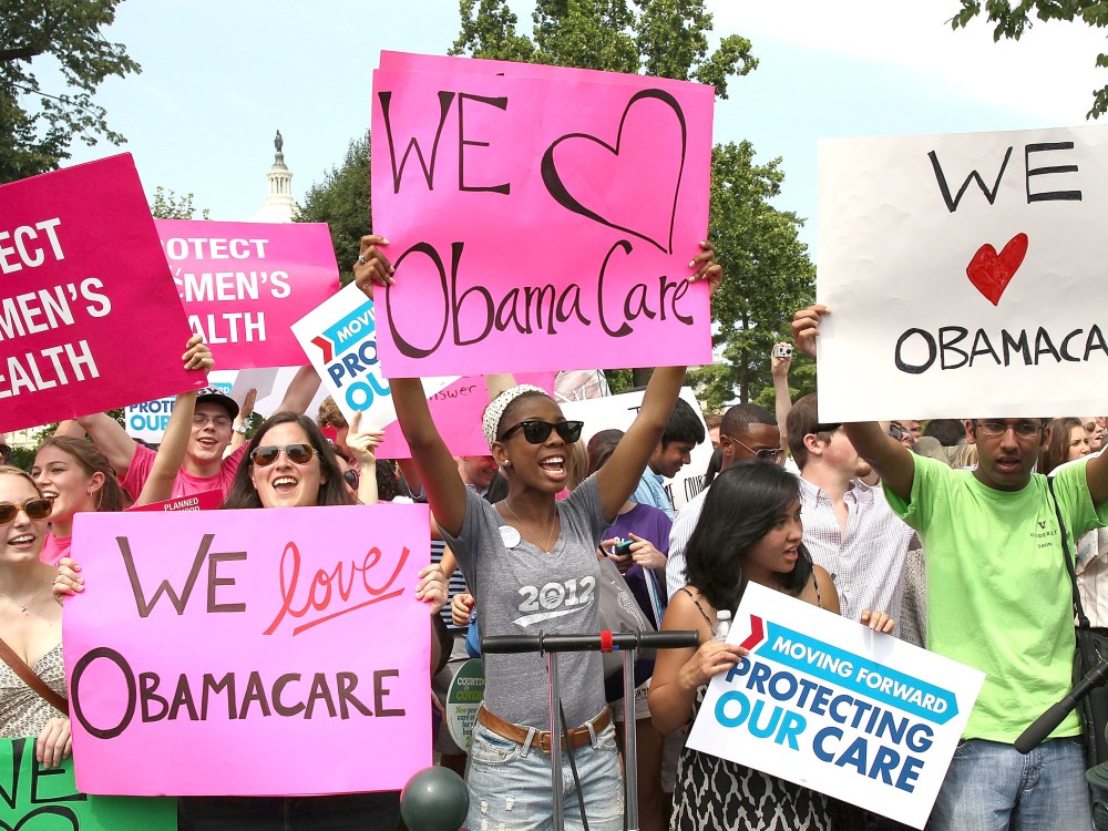 File Photo: Obamacare supporters react to the U.S. Supreme Court decision to uphold President Obama's health care law, on June 28, 2012 in Washington, DC. Today the high court upheld the whole healthcare law of the Obama Administration. (Photo by...