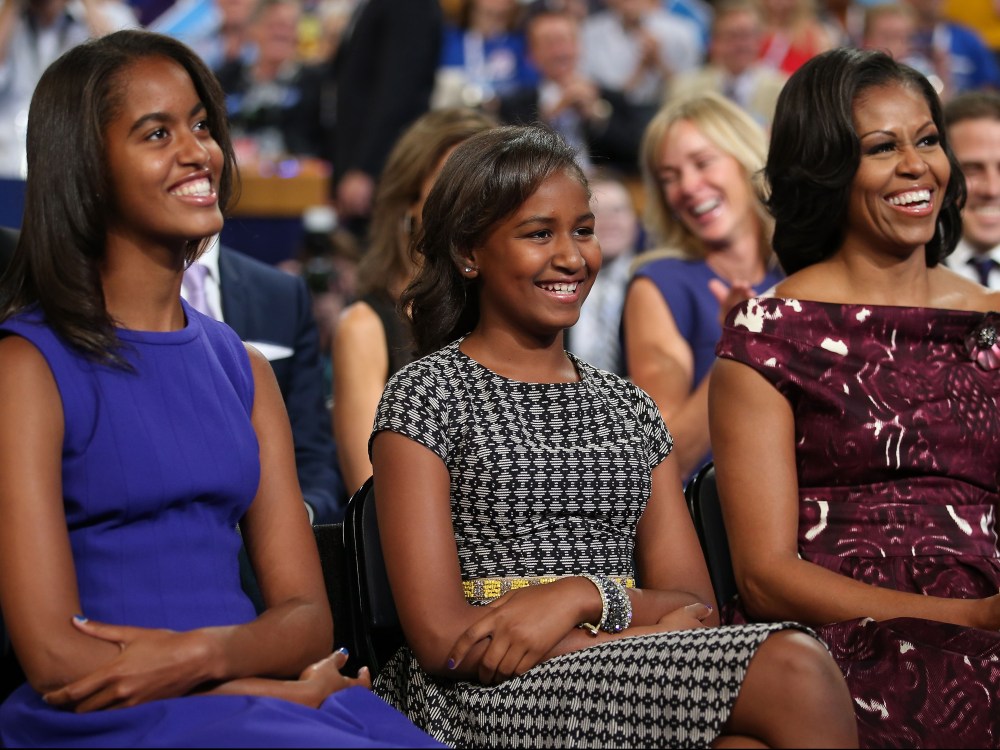 File photo: Malia Obama, Sasha Obama and first lady Michelle Obama listen as President Obama speaks at the DNC in Charlotte, North Carolina on September 6, 2012. (Photo by Chip Somodevilla/Getty Images)