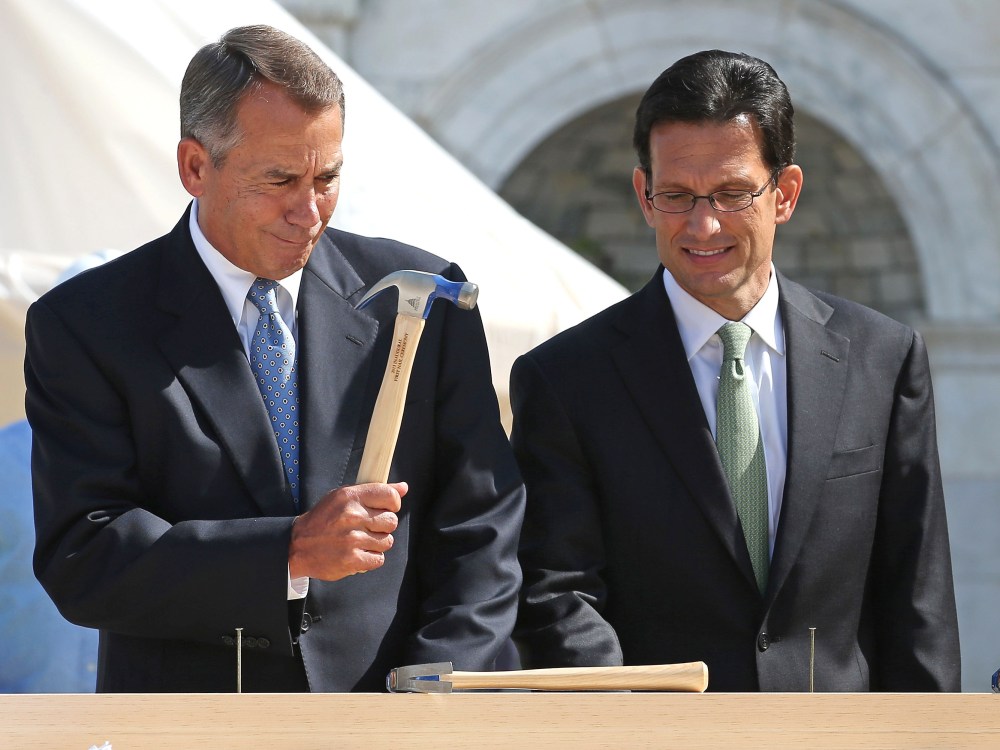 FILE PHOTO: Speaker of the House John Boehner (R-OH) (L) wields his hammer with House Majority Leader Eric Cantor (R-VA) before the "First Nail" ceremony, signifying the start of construction of the 2013 Inaugural Platform on the West Front of the U.S...