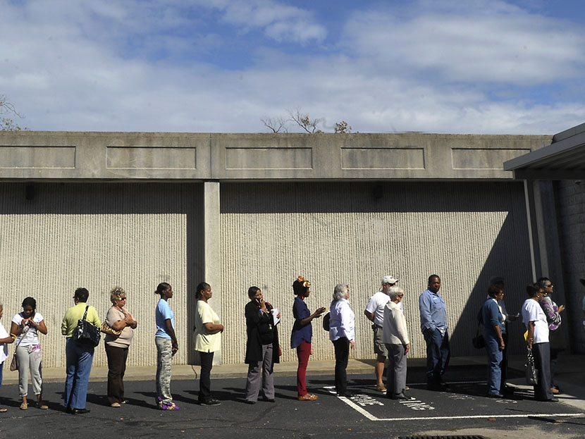 People wait in line to vote at the Board of Elections early voting site on October 18, 2012 in Wilson, North Carolina. (Photo by Sara D. Davis/Getty Images)