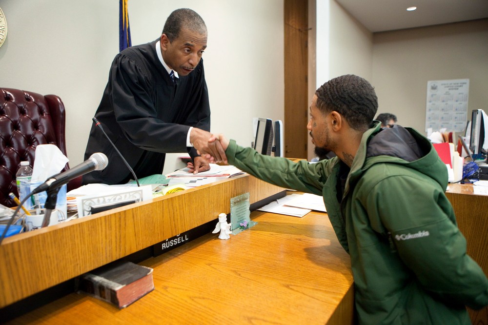 Judge Robert Russell, creator of the Buffalo Veterans Treatment Court, shakes hands with veteran Justin Smith who has succeeded in his court, on Oct. 23, 2012.