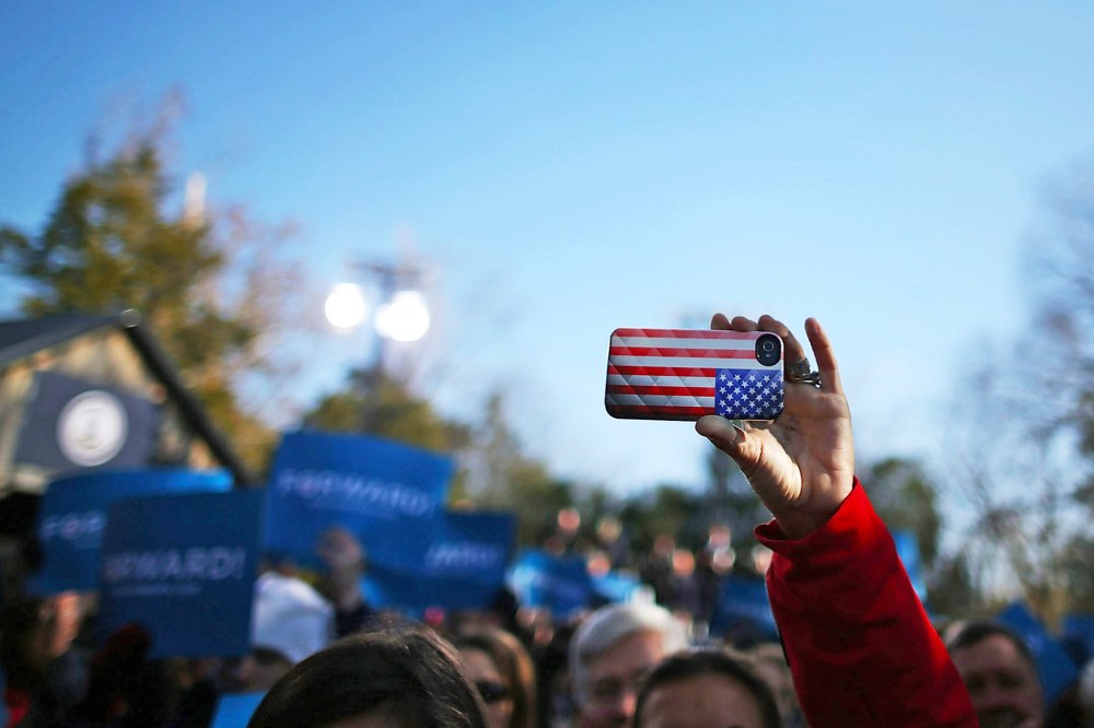 A cell phone with an American flag cover is held up during a rally in Sterling, Virginia.