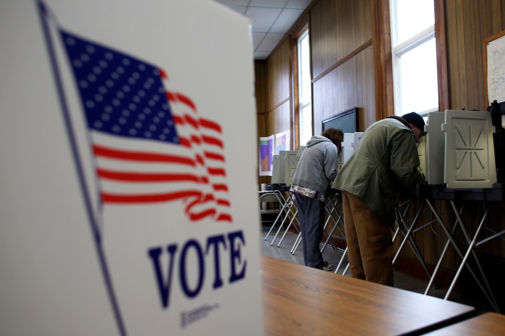 A man and woman cast their vote at a polling station on November 6, 2012 in Sugar Creek, Wisconsin.