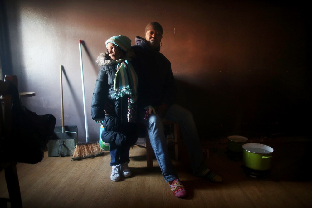 Mac Baker poses with her niece in her unheated apartment in the Ocean Bay public housing projects, Nov. 9, 2012.