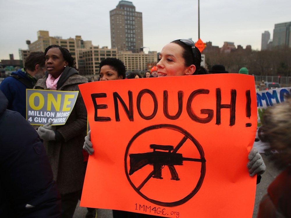 Participants with One Million Moms for Gun Control, a gun control group formed in the wake of last month's massacre at a Newtown, Connecticut elementary school, attend a rally and march across the Brooklyn Bridge on January 21, 2013 in New York City. ...