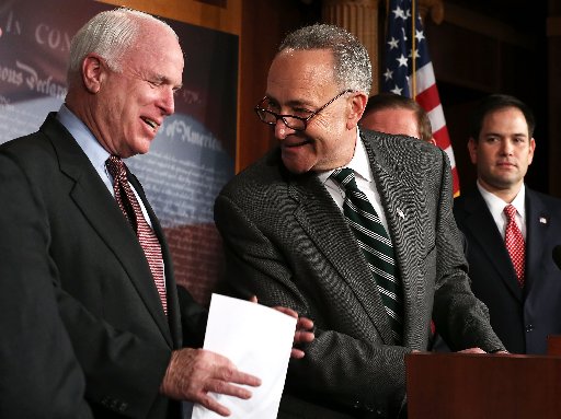 File photo: U.S. Sen. Charles Schumer (D-NY) (2nd L) and Sen. John McCain (R-AZ) (L) share a moment as Sen. Marco Rubio (R-FL) (R) looks on during a news conference on a comprehensive immigration reform framework January 28, 2013 on Capitol Hill in...