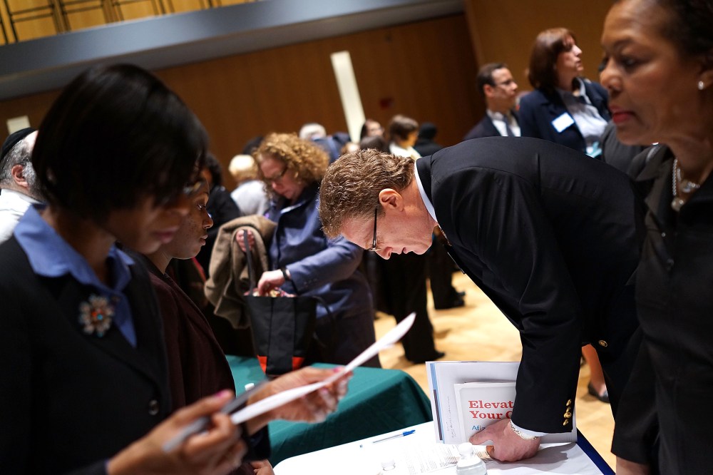 Job seekers speak to representatives of employers at a job fair at the Jewish Community Center in Manhattan on March 6, 2013 in New York, N.Y.