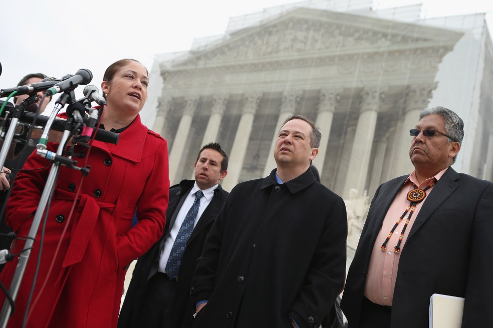 Mexican American Legal Defense and Education Fund Director of Litigation Nina Perales, MALDEF lawyer Luis Figaroa, Georgetown University law professor Jon Greenbaum and San Carlos Apache Tribal Chairman Terry Rambler talk with reporters outside the U.S...