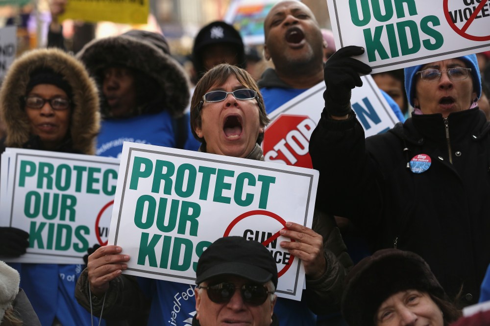 Demonstrators take part in a rally against gun violence on March 21, 2013 in the Harlem neighborhood of the Manhattan borough of New York City.