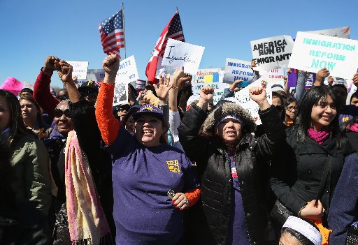 Demonstrators cheer during a "Time is Now" rally for immigration reform on April 6, 2013 in Jersey City, New Jersey. (Photo by John Moore/Getty Images)